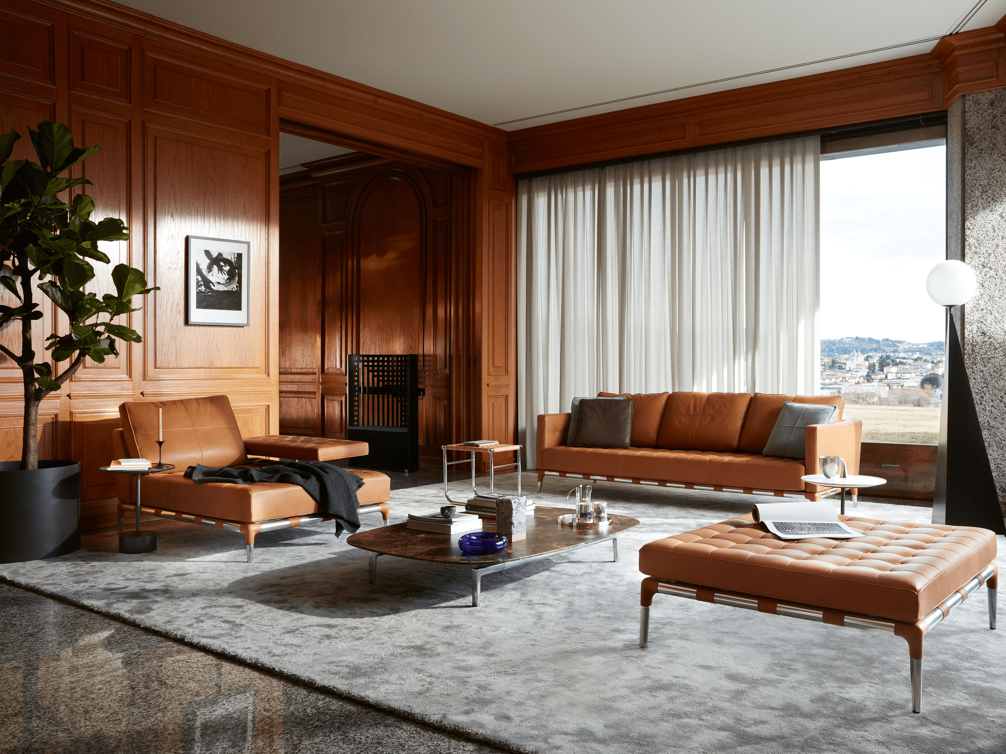 A Cassina living room with brown leather, warm wood and natural light